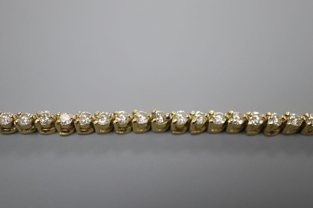 A modern 750 yellow metal and diamond set line bracelet, 18.5cm, gross 10.6 grams. 500